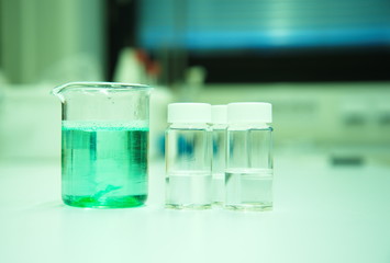 Wall Mural - green solution in beaker in science lab