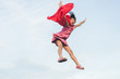 © nuiiko - Motion jumping to the sky with red fabric.
