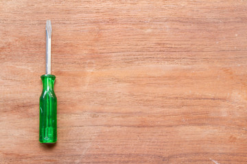 screwdriver on wood background