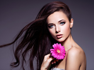 Wall Mural - Portrait of beautiful  young woman with long brown  hair with pi