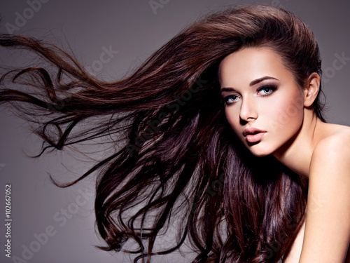 Naklejka ścienna Portrait of the beautiful young woman with long brown hair