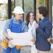 © alotofpeople - Worker shows house design plans