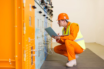 Poster - young electrical engineer working on laptop