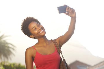 Attractive young african woman taking a selfie