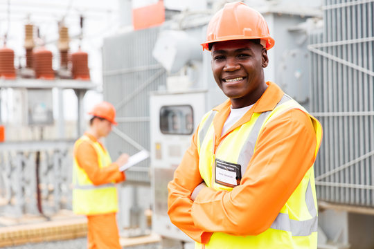 african technician with colleague on background