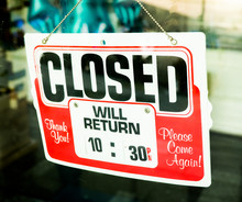 Vintage Retro Looking Closed Sign In A Shop Showroom With Reflec