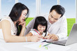 © Creativa Images - Asian parents teach their daughter to study