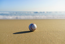 Baseball At A California Beach With White Wave In Pacific Ocean