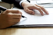 © Kittiphan - Human Hand Signing on Formal Paper at the workplace