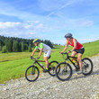 two cyclists on bike in nature