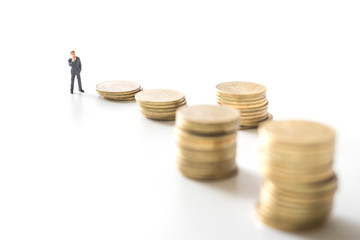 Businessman thinking in front of coins