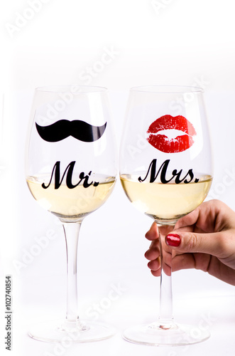 Plakat na zamówienie Two wine glasses with wine isolated on a white background. Glasses for woman and man. White wine. Happy lifestyle. Romantic. Rose. Pour a wine. Valentines background