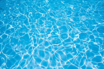 clean and bright water in swimming pool with sun reflection