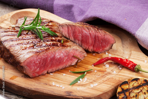 Fototapeta na wymiar Grilled beef steak with rosemary, salt and pepper