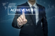 © tonefotografia - Businessman hand touching ACHIEVEMENT button on virtual screen