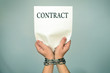 man with bound hands to hold a contract .