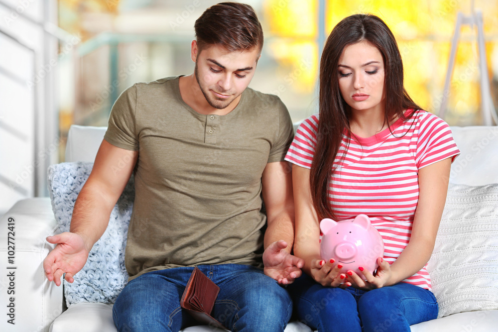 Happy couple counting money from the moneybox