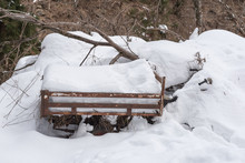 Old Rusty Wheelbarrow Under The Snow Covered