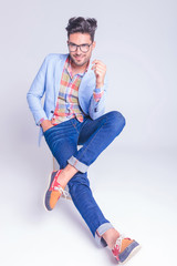 Poster - handsome man posing seated with legs crossed