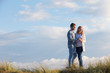 © micromonkey - Couple Walking Through Sand Dunes Together