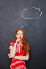 Sticker - Thoughtful woman thinking over blackboard background with blank bubble