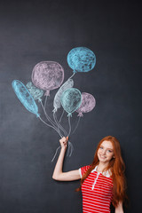 Poster - Happy woman holding balloons drawn on blackboard background