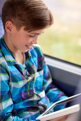 Sticker - happy boy with tablet pc in travel bus or train