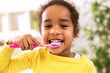 Little beautiful african girl brushing teeth