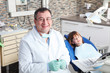 © sepy - Male dentist and young patient