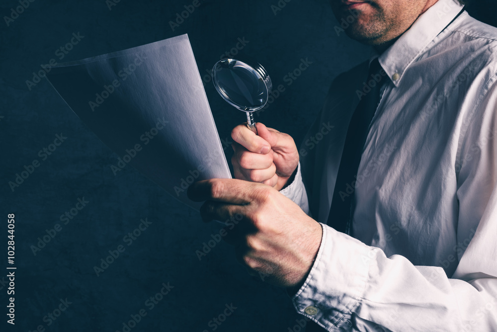 Tax inspector doing financial auditing, businessman reading business report or contract footnotes disclaimer with magnifying glass, retro toned, selective focus - obrazy, fototapety, plakaty 