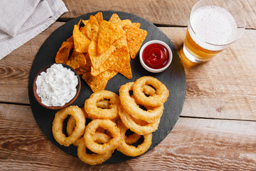 fried onion rings in batter with sauce tortilla chips