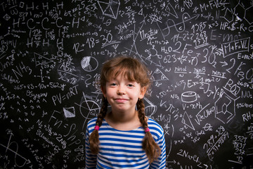 Girl  with two braids, big blackboard with mathematical symbols