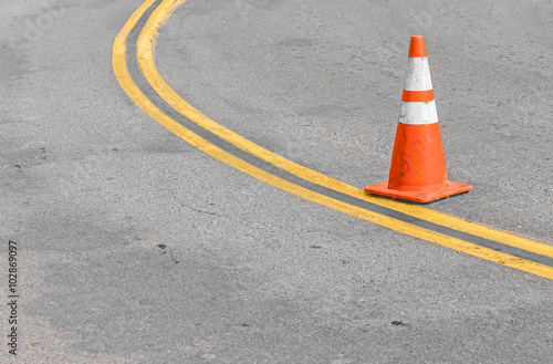 Fotografie, Obraz Orange traffic cone on double yellow lines