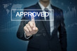 © tonefotografia - Businessman hand touching APPROVED button on virtual screen