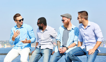 Young men relaxing on the riverside