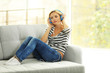 © Africa Studio - Young woman on a sofa listening to music