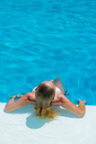 Fototapeta Abstrakcje - Woman relaxing at the pool