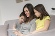 © Atelier 211 - Smiling mother and children using tablet