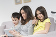 © Atelier 211 - Smiling mother and children using tablet