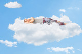 Fototapeta  - Tranquil scene of a woman sleeping on cloud