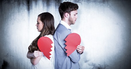 Wall Mural - Composite image of side view of couple holding broken heart