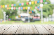Leinwandbild Motiv Empty wooden table with blurred party on background