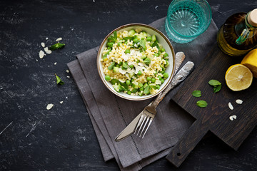 Wall Mural - Pasta salad (fregola) with green peas, cucumber, lemon and mint in the bowl 
 