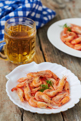 Wall Mural - Fresh shrimps on a plate on a wooden background, selective focus