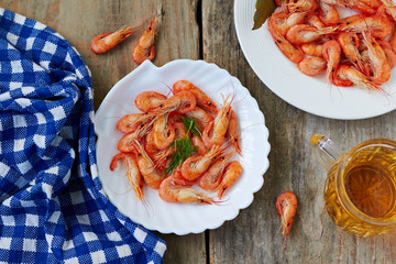 Wall Mural - Beer mug and fresh boiled shrimp on wood background, top view