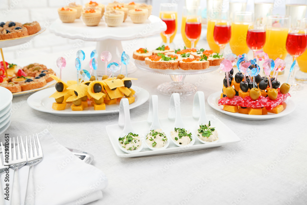 Set of cold snacks, canape, beverages, closeup