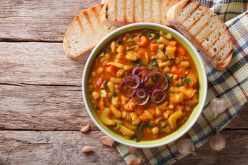 Poster - Italian ribollita vegetable soup close up in a bowl. Horizontal top view
