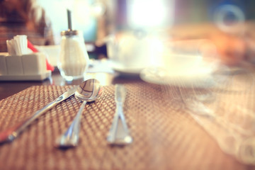 Wall Mural - cutlery on the table in a restaurant table setting, knife, fork, spoon, interior