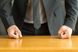 Businessman with clenched fist on the desk at office