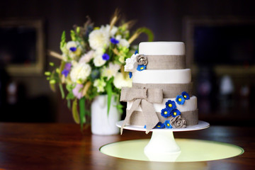 Wall Mural - Three stories wedding cake decorated with blue flowers